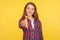 Welcome! Portrait of friendly sociable ginger girl in checkered shirt reaching out hand to camera, offering handshake