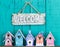 Welcome sign with bow by collection of birdhouses