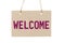 Welcome sign from cardboard paper hanging on rope