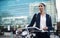 Welcome to the city, where opportunity awaits. Shot of a young businesswoman traveling with a bicycle through the city.