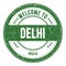 WELCOME TO DELHI - INDIA, words written on green stamp