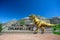 Welcome to Drumheller sign with dinosaur at the entrance to town in Drumheller