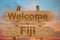 Welcome to Fiji sing on wood background