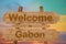 Welcome to Gabon sing on wood background with blending national flag