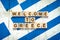 Welcome to Greece. The inscription on wooden blocks on the background of the flag of Greece