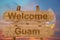 Welcome to Guam sing on wood background with blending national flag