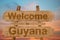 Welcome to Guyana sing on wood background