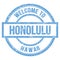 WELCOME TO HONOLULU - HAWAII, words written on light blue stamp