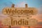 Welcome to India sing on wood background