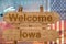 Welcome to Iowa state in USA sign on wood, travell theme