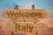 Welcome to Italy sing on wood background