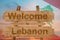 Welcome to Lebanon sign on wood background with blending national flag