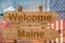 Welcome to Maine state in USA sign on wood, travell theme