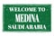 WELCOME TO MEDINA - SAUDI ARABIA, words written on green stamp