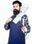 Welcome to my BBQ. Confident grill cook. Bearded man holding grilling basket and tools for barbecue. Master cook wearing