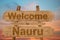 Welcome to Nauru sign on wood background