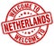 welcome to Netherlands red round stamp