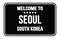 WELCOME TO SEOUL - SOUTH KOREA, words written on black street sign stamp