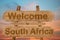 Welcome to South Africa sign on wood background