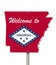Welcome to the state of Arkansas road sign in the shape of the state map with the flag