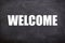 Welcome white text with blackboard background. (welcome and Hello)