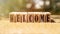 WELCOME word written on wooden blocks on table