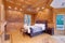 Welcoming mansion bedroom with a rustic wood coffered ceiling