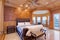 Welcoming mansion bedroom with a rustic wood coffered ceiling