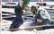 Welder construction workers working on city street crossroad, replacing old rotten tram rails with new once and arc welding them