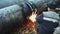 The welder cuts large metal pipes with ocetylene welding. Slow motion video
