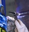 welder hands weld two pieces of metal using argon torch and filler rod, argon welding