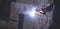 Welder performs welding work on metal