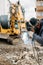 welder with protection gear and mask welding broken excavator arm