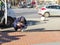 A welder with a protective mask and gloves squats and carries out a welding works or urgent repairs on a city street