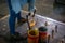 A welder is using a Stud Welding Machine to weld stud bolt on steel plate, at industrial factory