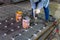 A welder is using a Stud Welding Machine to weld stud bolt on steel plate, at industrial factory