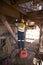 Welder wearing full safety equipment glove, mask using and standing up on industry safety steps while commencing welding parent me