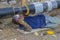 Welder welding underground steel pipe lying on ground 4