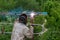 Welder at work. Welder cooks metal grate on the ground blowtorch on the ground in special clothes and mask welder.