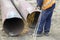 Welder worker cutting hole in metal