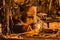 Welder worker in a protective iron mask repairs the car door and is engaged in welding work in the shop of the industrial plant