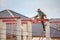 Welder workers installing steel frame structure of the house