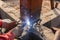 Welding metal and wood by electrode with bright electric arc