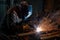 welding sparks fly as metal is joined in factory