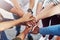 Well achieve a lot more as one. Closeup shot of a group of people joining their hands together in a huddle.