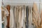 Well arranged closet showcases a range of neutral colored womens clothing, exuding simplicity, elegance.