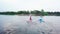 Well-coordinated team kayaking on lake