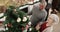 Well done, babe. 4k video footage of an affectionate senior couple standing together and decorating their Christmas tree