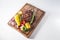 Well done steak with grilled vegetables on wooden board