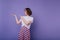 Well-dressed cute brunette woman posing on purple background. Studio shot of enthusiastic caucasian